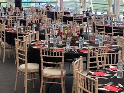Table 13 dressed with champagne bottles, red roses and red napkins
